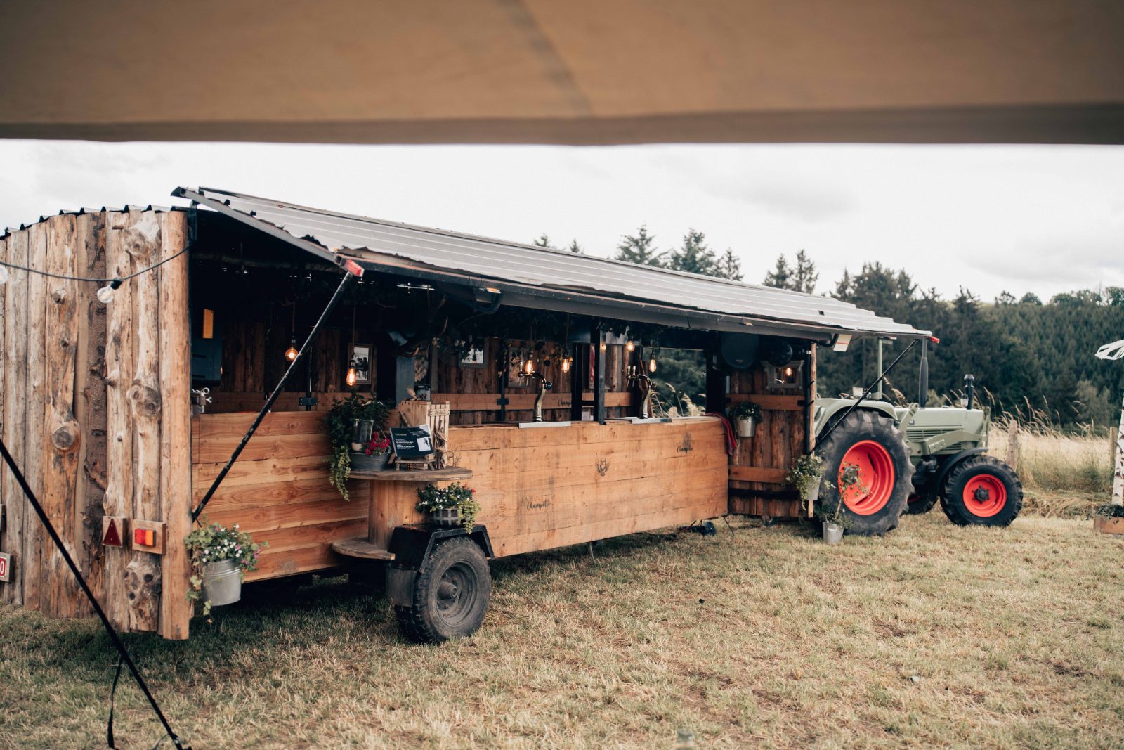 La Buvette Champêtre tirée par son vieux tracteur dans une prairie